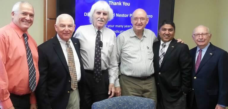 Professors David Talty and Nestor Portocarrero standing with Chaplin School administrators at retirement reception