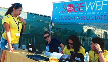 Students checking in at the student associates table at the Food Network South Beach Food and Wine Festival presented by Food and Wine