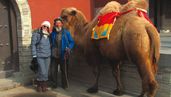 Student and local posing with a camel